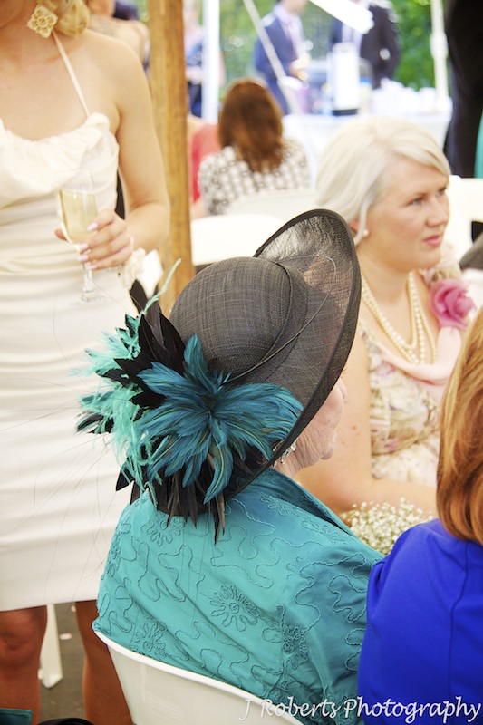 Feather hat at garden party wedding - wedding photography sydney